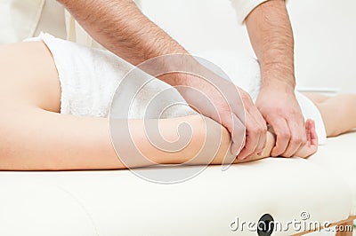 Close-up of male hands getting a woman forearm massage Stock Photo