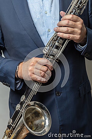 Close-up of male hands holding bass clarinet, cropped photo Stock Photo