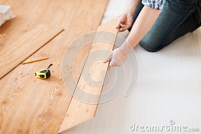 Close up of male hands intalling wood flooring Stock Photo