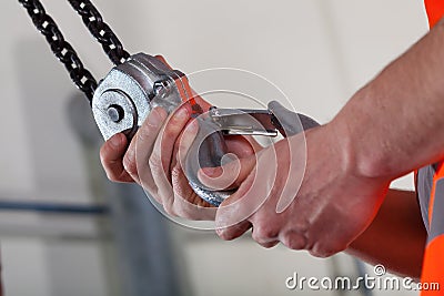 Close-up of male hands and lifting hook Stock Photo