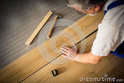 close up of male hands lying parquet floor board Stock Photo