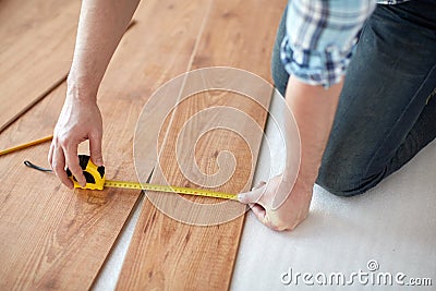 Close up of male hands measuring flooring Stock Photo