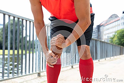 Jogger Having Pain In His Knee Stock Photo