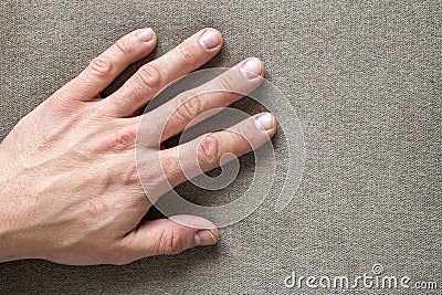 Close-up of male masculine hand with rough skin and short fingernails resting on flat copy space background, top view. Manual Stock Photo