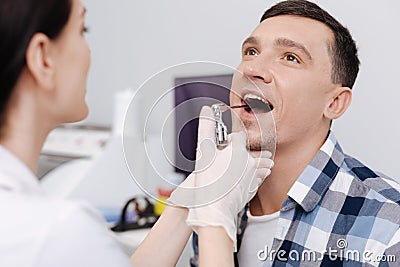 Close up of male patient sitting with opened mouth Stock Photo