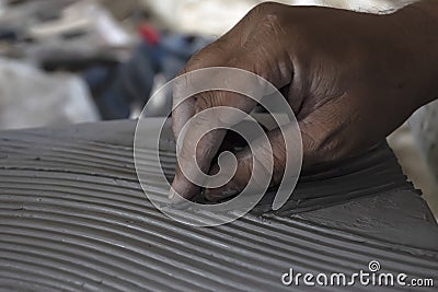 Close up of male sculptor making art on clay using hands. Clay master moulding. Clay modelling. Stock Photo