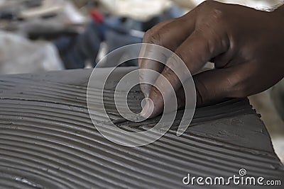Close up of male sculptor making art on clay using hands. Clay master moulding. Clay modelling. Stock Photo