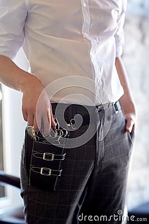 Close up of male stylist with tool case at salon Stock Photo