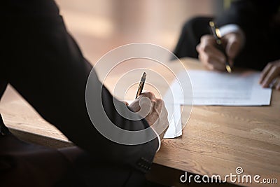 Close up of business partners sign contract at meeting Stock Photo