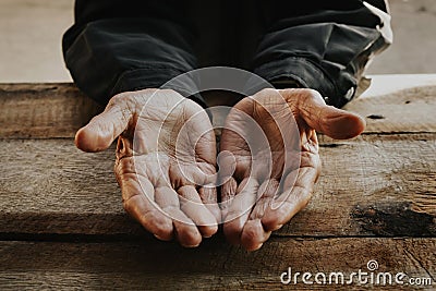 Close up of male wrinkled hands, old man is wearing on the wood. vintage tone Stock Photo