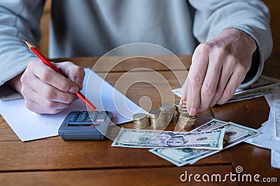 Close up man with calculator counting, making notes at home, han Stock Photo