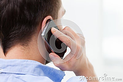 Close up of man calling on smartphone at home Stock Photo