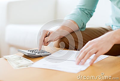 Close up of man counting money and making notes Stock Photo