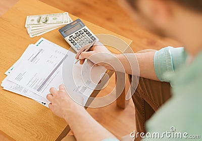 Close up of man counting money and making notes Stock Photo