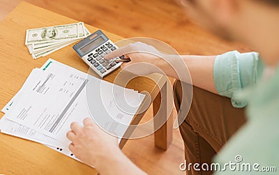 Close up of man counting money and making notes Stock Photo