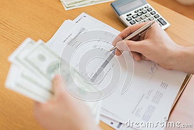 Close up of man counting money and making notes Stock Photo