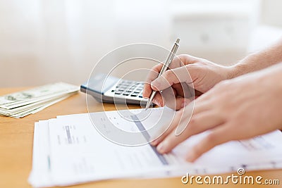 Close up of man counting money and making notes Stock Photo