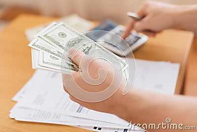 Close up of man counting money and making notes Stock Photo