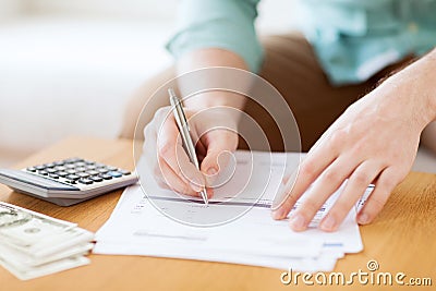 Close up of man counting money and making notes Stock Photo