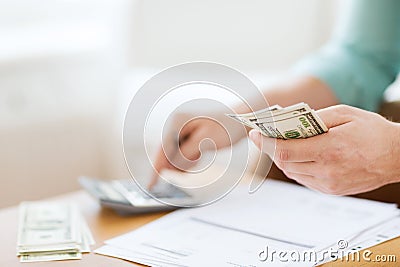 Close up of man counting money and making notes Stock Photo