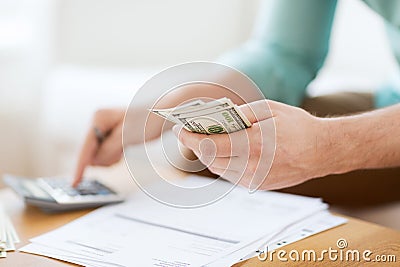 Close up of man counting money and making notes Stock Photo