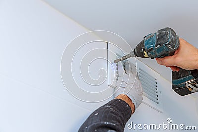 Close up man hand installing vent cover from ceiling Stock Photo