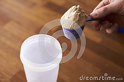 Close Up Of Man Mixing Protein Shake In Cup Stock Photo