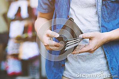 Close up man person holding an empty wallet in the hands of an man no money out of pocket Stock Photo