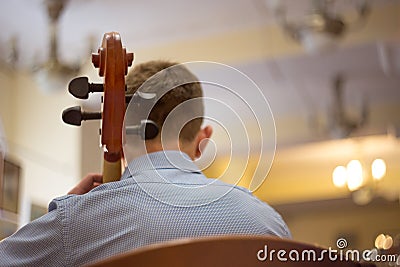 close up of a man playing the cello, a real concert, rear view Stock Photo