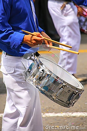 Close up of a man playing drum during Festival of the Virgin de Editorial Stock Photo