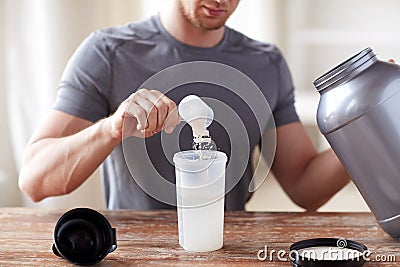 Close up of man with protein shake bottle and jar Stock Photo