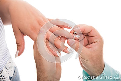 Close up of man putting engagement ring on girlfriend finger Stock Photo