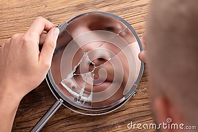 Man`s Face In Broken Mirror Stock Photo