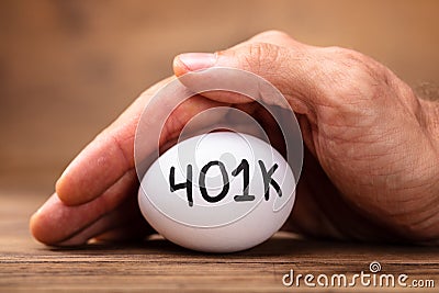 Man Protecting 401k White Egg Stock Photo