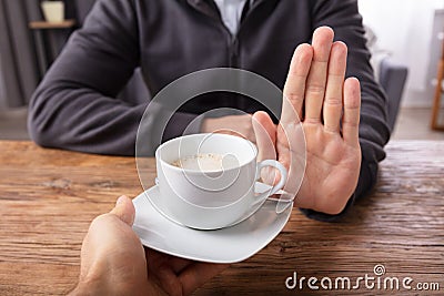 Man Refusing Cup Of Coffee Offered By Person Stock Photo