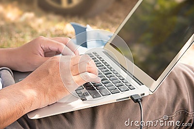 Close up Man`s hand are using their laptops on the legs Stock Photo