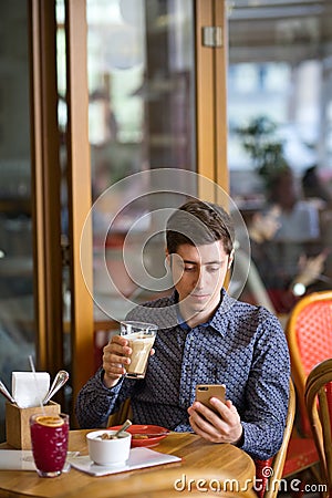 Man with coffee and smartphone Stock Photo