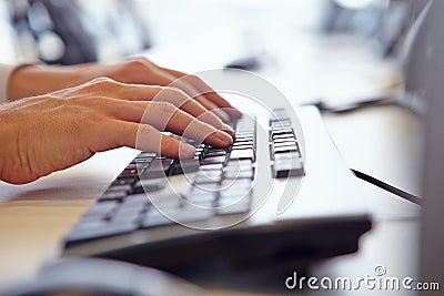 Close up of man?s hands using the keyboard of a computer Stock Photo