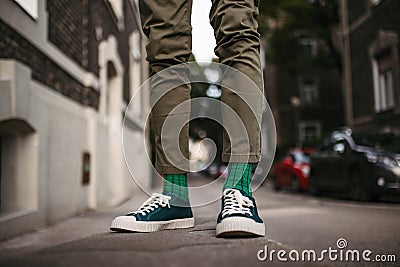 Close-up of a man& x27;s stylish shoes and quirky socks standing on the street. Stock Photo