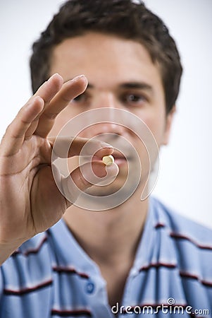 Close up man showing pill Stock Photo