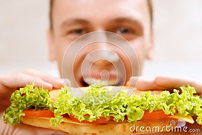 Close up of man taking bite sandwich Stock Photo