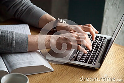 Close up of male typing on laptop studying in cafe Stock Photo