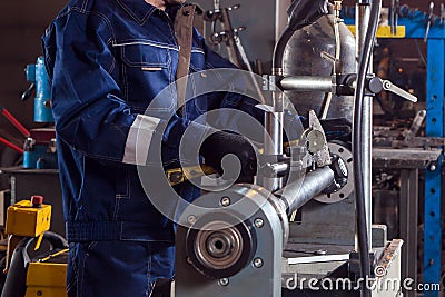 Close-up of a man works with a mettalic hammer Stock Photo