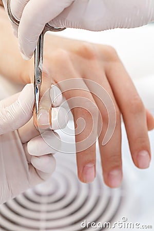Close up of manicurist using manicure scissors Stock Photo