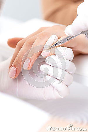 Close up of manicurist using manicure scissors Stock Photo