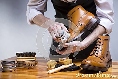 Close Up of Mans Hands Cleaning Luxury Calf Leather Brogues with Special Accessories, Shoe Wax and Tools Stock Photo