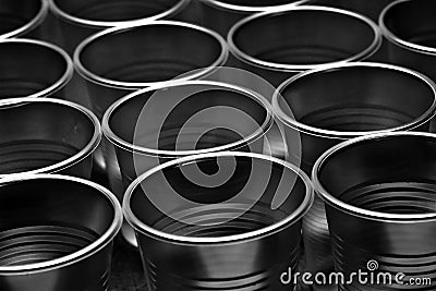 Close up of many empty translucent plastic cups, ordered in rows. Shallow depth of field. Intentionally underexposed Stock Photo