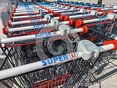 Close-up of many shopping carts marked with the logo of a Super U supermarket, Veynes, France Editorial Stock Photo