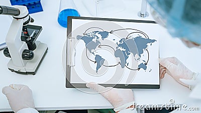 Close up. map of the spread of coronavirus in the hands of an epidemiologist. Elements of this image furnished by NASA Stock Photo