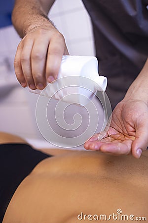 Close up of masseur hands with oil before start Stock Photo